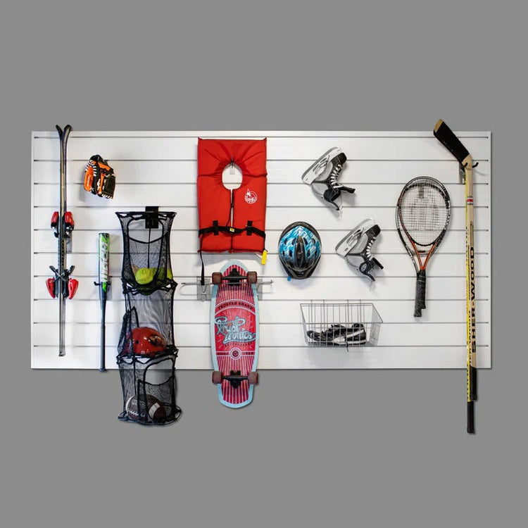 Organized garage slatwall wall holding tools, hooks, and baskets.