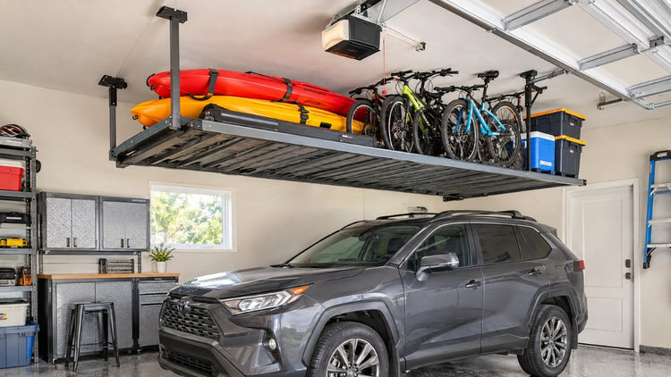 Kayaks and bikes stored overhead on a motorized garage ceiling lift above a parked car.